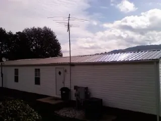 New metal roof on a single wide mobile home with a TV antenna in Dundee